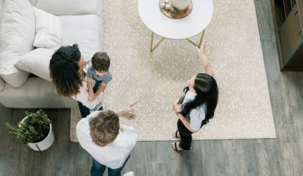 three adults standing in livingroom